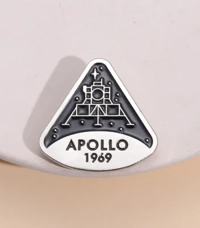 Une broche ou badge représentant la mission Apollo 11 de la NASA, avec la date 1969, symbole emblématique de l'exploration spatiale.