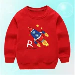 Vêtement pour enfant rouge avec motif de fusée et étoiles, parfait pour les amateurs d'astronomie et de science.