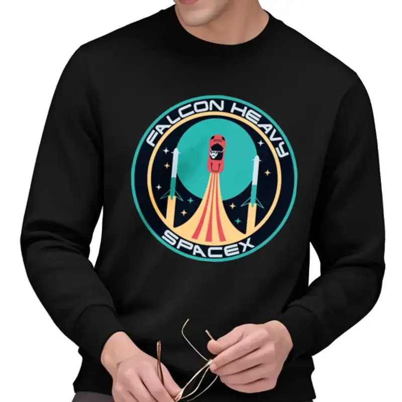 pull-spacex-falcon-heavy-1 T-shirt noir avec logo Falcon Heavy SpaceX, représentant une fusée en lancement avec un fond étoilé, idéal pour les passionnés d'aérospatiale et de technologie spatiale.