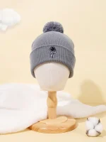Bonnet en laine gris avec pompon, idéal pour l'hiver, avec logo scientifique.