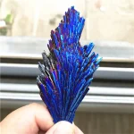 Cristal d'azur brillant avec des reflets iridescents, présenté dans une main pour une décoration scientifique unique.