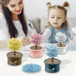 Petit arbre en cristal coloré dans un pot, idéal pour décoration ou activité ludique pour enfants, avec une mère et une fille jouant ensemble.
