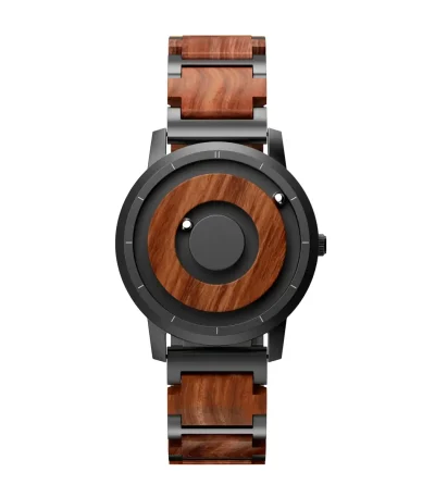 Montre en bois et métal avec design moderne et sophistiqué, alliant matériaux naturels et finition élégante. Parfaite pour un style unique et écologique.