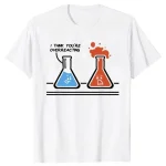 T-shirt blanc avec illustration de deux fioles de laboratoire, une bleue et une rouge, exprimant une réaction chimique humoristique avec texte "I think you're overreacting".
