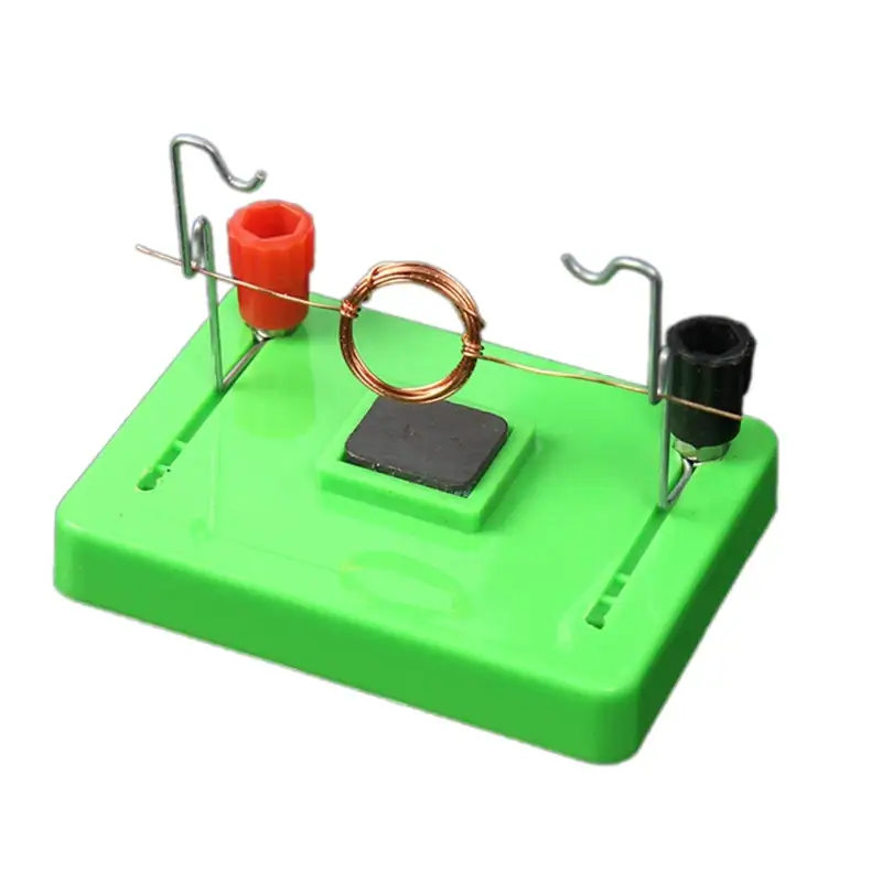 jeu-pedagogique-electromagnetique-1 Puce de démonstration d'induction électromagnétique avec bobine de cuivre, aimants et base en plastique vert, utilisée pour illustrer le principe de l'induction électromagnétique en physique.