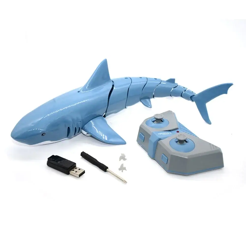 robot-requin-telecommande-1 Requin robot éducatif en plastique bleu avec télécommande, clé USB et accessoires pour apprentissage interactif.