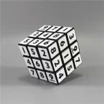 Cube puzzle noir et blanc avec chiffres et lettres, décoration de style scientifique ou éducatif.